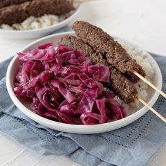 A picture of Beef Kebabs with Sautéed Red Cabbage and Rice with Fresh Thyme.