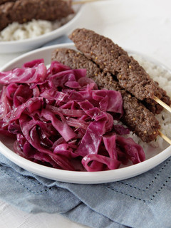 A picture of Beef Kebabs with Sautéed Red Cabbage and Rice with Fresh Thyme.
