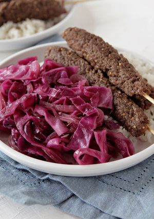 A picture of Beef Kebabs with Sautéed Red Cabbage and Rice with Fresh Thyme.
