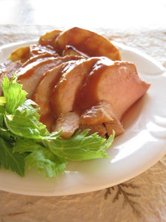 A picture of Roast Pork and Apple with Mustard and Ketchup.