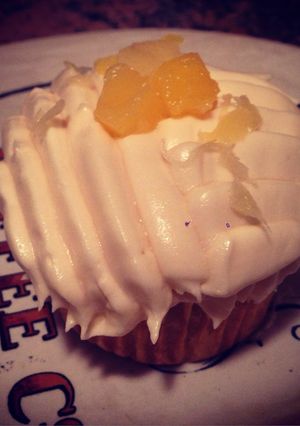 A picture of Pineapple & Coconut Cupcake W/ Coconut Frosting & Pineapple Shredding On Top.