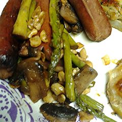 A picture of Asparagus, mushrooms cashews and splitdogs.