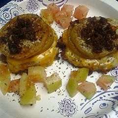 A picture of Green tomatoes atop sausage.