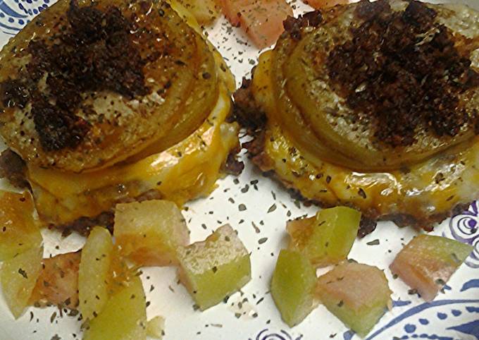 Green tomatoes atop sausage