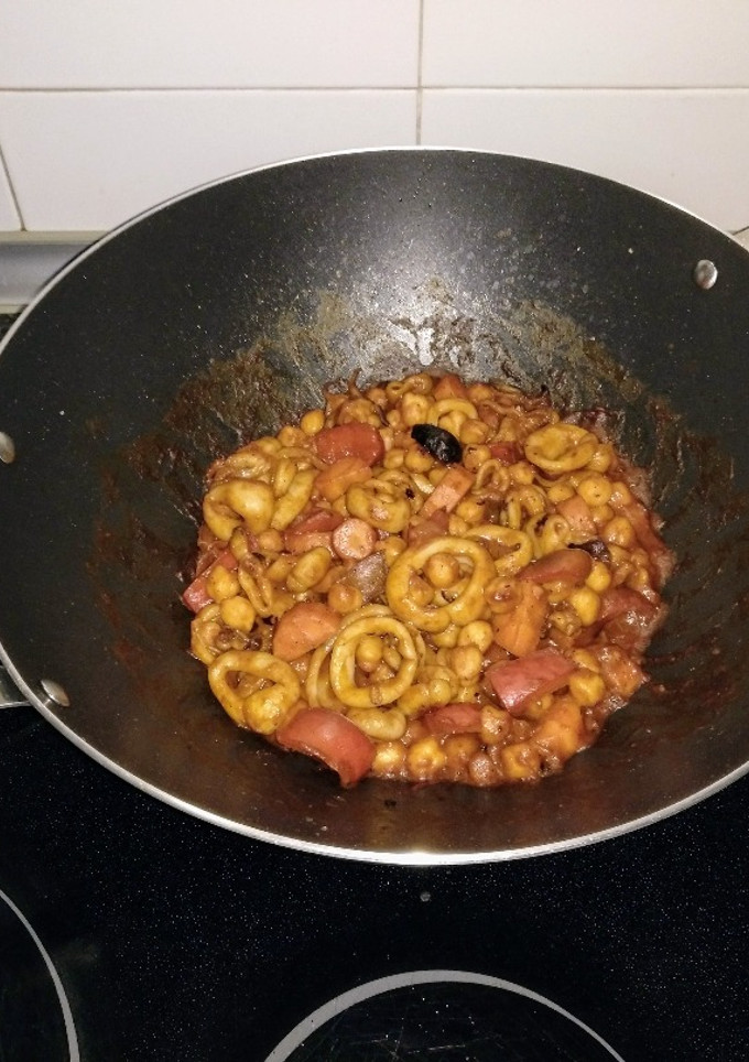 Una foto de Wok de calamares en salsa picante con garbanzos