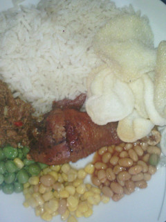 A picture of White Rice and Abykahuna Sauce with peppered saulted baked beans,sweet corn and green peas with driz.