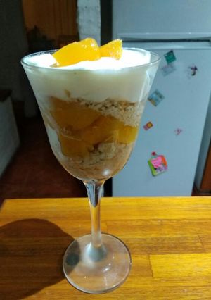 Una foto de Postre de durazno crema dulce de leche y galletitas