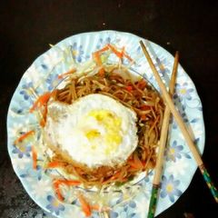 A picture of Veggie noodles with mint leaves.