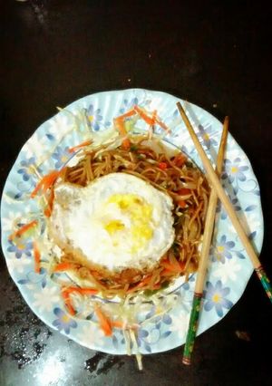 A picture of Veggie noodles with mint leaves.