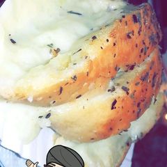 A picture of Garlic bread with cheese.