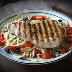 A picture of Blue Marlin over Mushroom and Pepper Pasta.