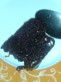 A picture of Ultra moist chocolate cake with chocolate sauce.