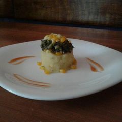 A picture of Mashed Potatoes Topped with Sautee Spinach(Sweet corns).