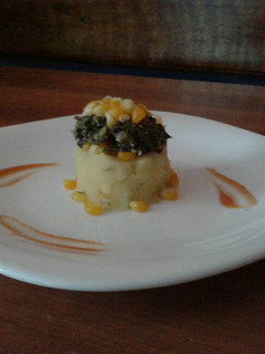 A picture of Mashed Potatoes Topped with Sautee Spinach(Sweet corns).