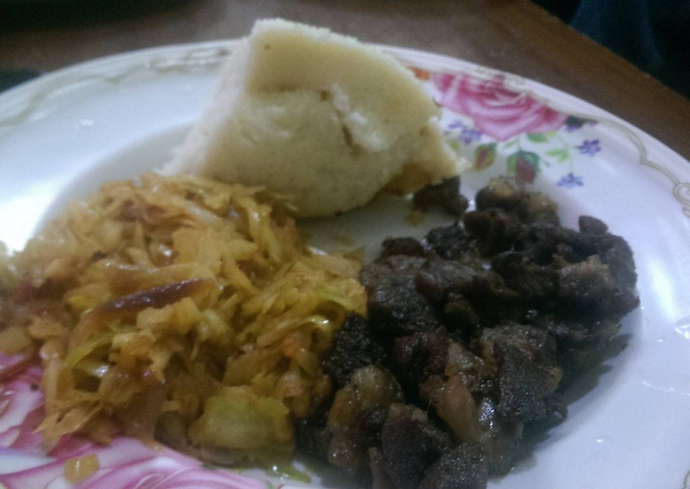 Fried lamb,steamed cabbage served with ugali
