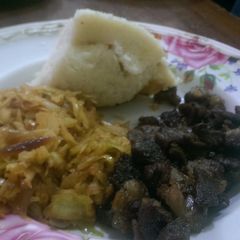 Fried lamb,steamed cabbage served with ugali A picture of Fried lamb,steamed cabbage served with ugali.