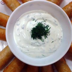 A picture of Vegie spring rolls with sour cream dipping.