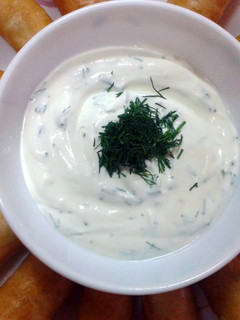 A picture of Vegie spring rolls with sour cream dipping.