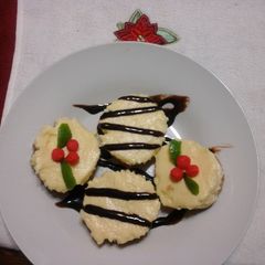 A picture of No bake classic cheese cake with chocalate or christmas themed toppings.