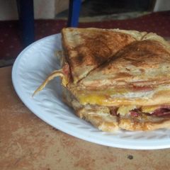 A picture of Bread toasted with Egg, Sausage, and Sardine.