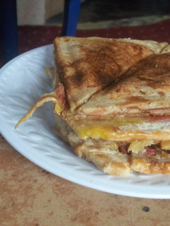 A picture of Bread toasted with Egg, Sausage, and Sardine.