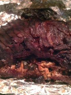 A picture of Stuffed Tri-Tip wrapped in Bacon.