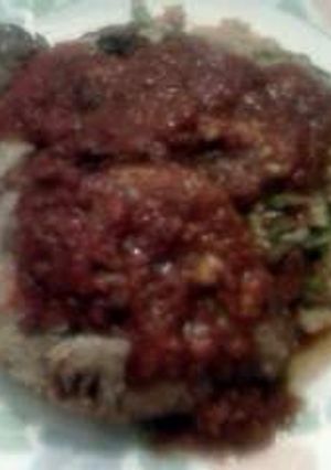 A picture of Bacon & provolone stuffed pork roast topped w bacon & Stew tomato flvr brown rice w gr beans!.