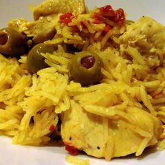 A picture of Spanish rice with chicken.