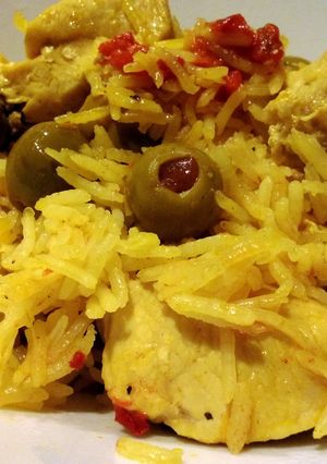 A picture of Spanish rice with chicken.