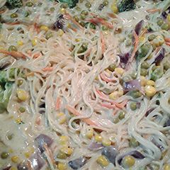 A picture of mushroom Alfredo with veggies and canton noodles.