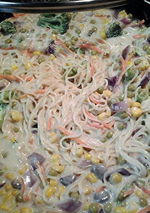 A picture of mushroom Alfredo with veggies and canton noodles.