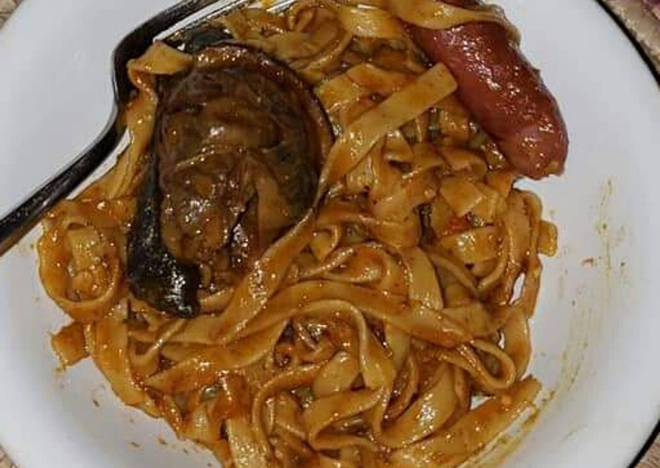 Pasta with sausage and fried fish