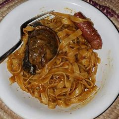 A picture of Pasta with sausage and fried fish.