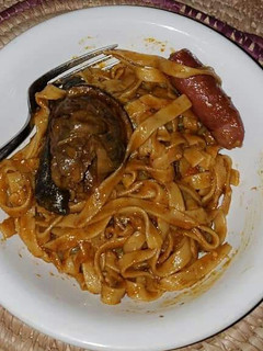 A picture of Pasta with sausage and fried fish.