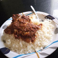 A picture of White Rice and stew with Beef.