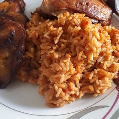 A picture of Jollof rice and fried chicken.