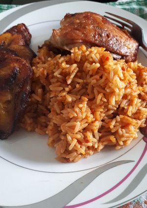 A picture of Jollof rice and fried chicken.