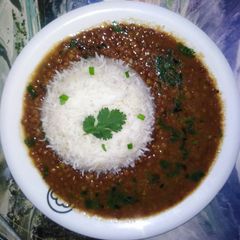 A picture of Brown lentils with spring rice (masoor aur hari payaz k chawal).