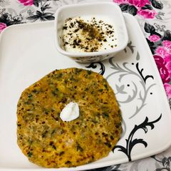 A picture of Paneer Parantha with Fresh Butter.