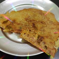 A picture of Onion Rava Dosa with nariyal chutney, sambar.