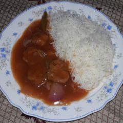 A picture of Chicken manchurian with plain rice.