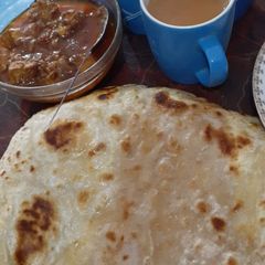Paratha with salan and tea A picture of Paratha with salan and tea.