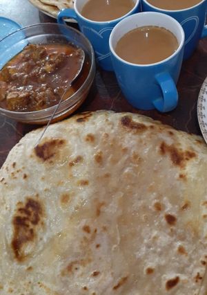 A picture of Paratha with salan and tea.