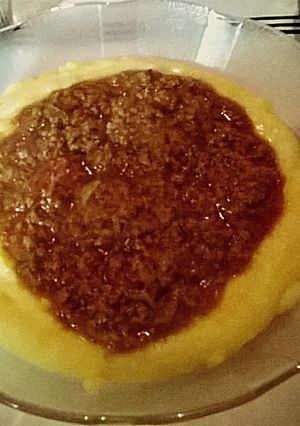 Una foto de Polenta cremosa con Bolognesa