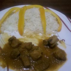 A picture of Stewed pork served with white rice.