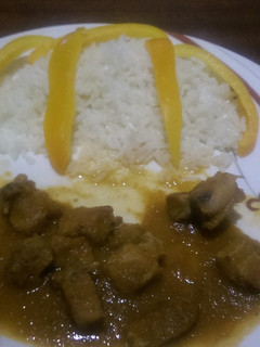 A picture of Stewed pork served with white rice.