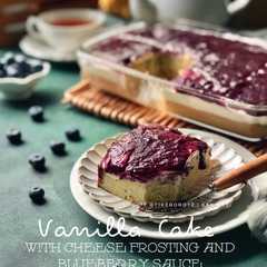 A picture of VANILLA CAKE with CHEESE FROSTING & BLUEBERRY SAUCE.