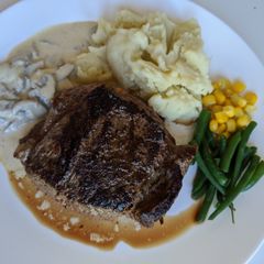 A picture of Homemade steak and mashed potato with garlic and pepper sauce.