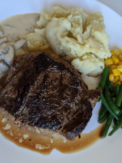A picture of Homemade steak and mashed potato with garlic and pepper sauce.