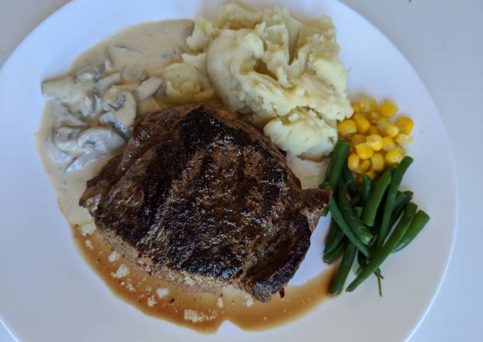 Homemade steak and mashed potato with garlic and pepper sauce